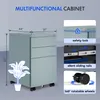 A collage showcasing a light blue filing cabinet with dimensions, close-ups of its features like a safety lock, silent sliding rails, and rotatable wheels. A stylized plant is overlaid on the cabinet. Produktbild-Vorschau