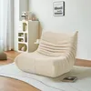 A modern living room setting with a beige beanbag chair on a rug, next to a storage unit and a wall art. Produktbild-Vorschau