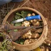 A wooden bowl filled with freshly harvested root vegetables and a knife. Náhled obrázku produktu