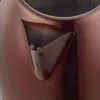 A close-up view of the spout of a copper-colored kettle. Voir les images du produit
