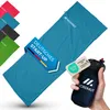 A hand holding a rolled-up sleeping bag next to an unrolled sleeping bag, with other sleeping bags in various colors in the background. Produktbild-Vorschau