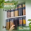A kitchen cabinet filled with clear storage containers holding various food items like pasta, cereal, and candies. A hand is reaching for one of the containers. Anteprima dell’immagine prodotto