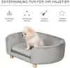 A small dog sits on a gray pet sofa with wooden legs. Above the sofa, there are icons and text describing the product's features. Produktbild-Vorschau