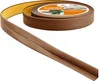 A roll of brown flexible skirting board with adhesive backing is shown, partially unrolled. Náhled obrázku produktu