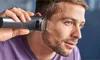 A man is trimming his beard with an electric trimmer. Anteprima dell’immagine prodotto