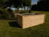 A wooden raised garden bed sits on a grassy lawn with trees and bushes in the background. Produktbild-Vorschau