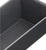 A close-up view of the interior of a dark gray, rectangular baking pan with a textured surface. Podgląd zdjęcia produktu