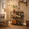 A bar cart filled with bottles and glasses in a living room setting. Produktbild-Vorschau
