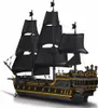 A black and gold pirate ship model with black sails, set against a white background. Podgląd zdjęcia produktu