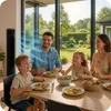 A family is having dinner at a table with a modern tower fan blowing air in the background. Náhled obrázku produktu