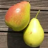Two pears are placed on a wooden surface. Produktbild-Vorschau