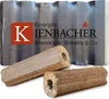 Two briquettes are in the foreground, with a package of briquettes in the background. The brand logo and name are visible on the package. Produktbild-Vorschau