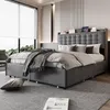 A modern bedroom with a grey upholstered bed as the main focus, featuring a headboard with built-in shelves and storage drawers. Anteprima dell’immagine prodotto