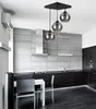 A modern kitchen with a dining table and chairs, featuring a sleek design and a pendant light fixture. Produktbild-Vorschau