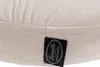 A close-up view of a cream-colored fabric with a black label attached. Podgląd zdjęcia produktu