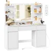 A white vanity table with a mirror and lights, featuring various makeup and skincare products on its shelves and surface. Produktbild-Vorschau