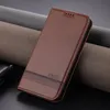 A brown leather phone case is displayed on a dark surface with textured fabric rolls in the background. Produktbild-Vorschau