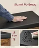 A hand touching a black cushioned seat, with inset images showing the cushion thickness and water resistance. Produktbild-Vorschau