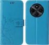 A blue flip phone case with a floral and butterfly design on the front cover and a camera cutout on the back cover. Produktbild-Vorschau