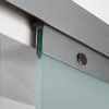 A close-up view of a sliding glass door system, focusing on the top track and roller mechanism. Produktbild-Vorschau