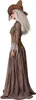 A woman in a witch costume, shown from the side. Produktbild-Vorschau
