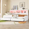 A white daybed with drawers and a headboard with shelves, illuminated by pink ambient lighting, is shown in a bedroom setting. Náhled obrázku produktu