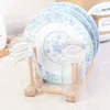 A dish rack holding plates and glasses. Produktbild-Vorschau