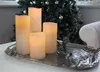 Four LED candles are arranged on a silver tray in front of a decorated Christmas tree. Podgląd zdjęcia produktu