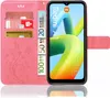 A pink flip case for a Xiaomi Redmi A1 phone, with cards and euro banknotes inserted into the case's slots. The phone screen displays a colorful abstract image. Produktbild-Vorschau