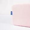 A close-up of a pink pillow with a blue tag. Anteprima dell’immagine prodotto