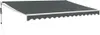 A dark gray retractable awning with a white trim and scalloped edge is shown extended against a white background. A black cord hangs from the left side of the awning mechanism. Náhled obrázku produktu