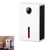 A white dehumidifier with a digital display and a red indicator light is shown against a white background. A smaller inset image shows the dehumidifier in a room setting. Produktbild-Vorschau