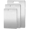 Three stainless steel cutting boards of different sizes are stacked and displayed against a white background. Anteprima dell’immagine prodotto