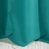 A close-up view of a teal-colored fabric, likely a curtain or tablecloth, draped over a wooden surface. Produktbild-Vorschau