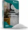 A bag of sand for paving stones with a pile of sand in front of it. Voir les images du produit