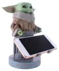 A figurine of Grogu from Star Wars holding a smartphone. Anteprima dell’immagine prodotto