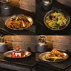 A collage of four food items presented on metal plates, set against a brick wall and industrial-style shelving. Náhled obrázku produktu