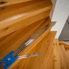 A close-up view of a stair measuring tool on wooden stairs. Náhľad obrázku produktu