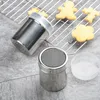 Two stainless steel powder shakers are shown on a gray surface, with a baking rack and cookies in the background. Produktbild-Vorschau