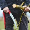 A person holding a pruning saw and a branch. Produktbild-Vorschau