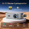 A projector is displayed on a pedestal in a desert-like setting with text overlays highlighting its features. Produktbild-Vorschau