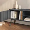 A close-up view of a dark gray TV stand with an open cabinet door, revealing books and decorative vases on top. Anteprima dell’immagine prodotto