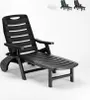 A black plastic lounge chair is shown against a white background. Several other lounge chairs in different colors (white, dark green, black) are visible in the background. Produktbild-Vorschau