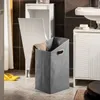 A bathroom scene with a laundry basket and sink. Produktbild-Vorschau
