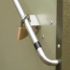 A close-up view of a metal storage box with a padlock securing a handle. Náhľad obrázku produktu