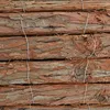A close-up view of stacked tree bark pieces, bound together with white twine. Anteprima dell’immagine prodotto
