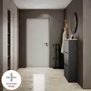 A modern hallway with a white door, shoe cabinet, and coat rack. Produktbild-Vorschau