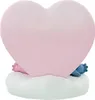 A pink heart-shaped object with blue and pink feet peeking out from underneath, resting on a white cloud-like base. Anteprima dell’immagine prodotto