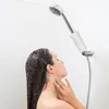 A woman is taking a shower with a shower filter attached to the shower head. Anteprima dell’immagine prodotto