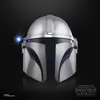 A close-up studio shot of a Mandalorian helmet against a black background. Voir les images du produit